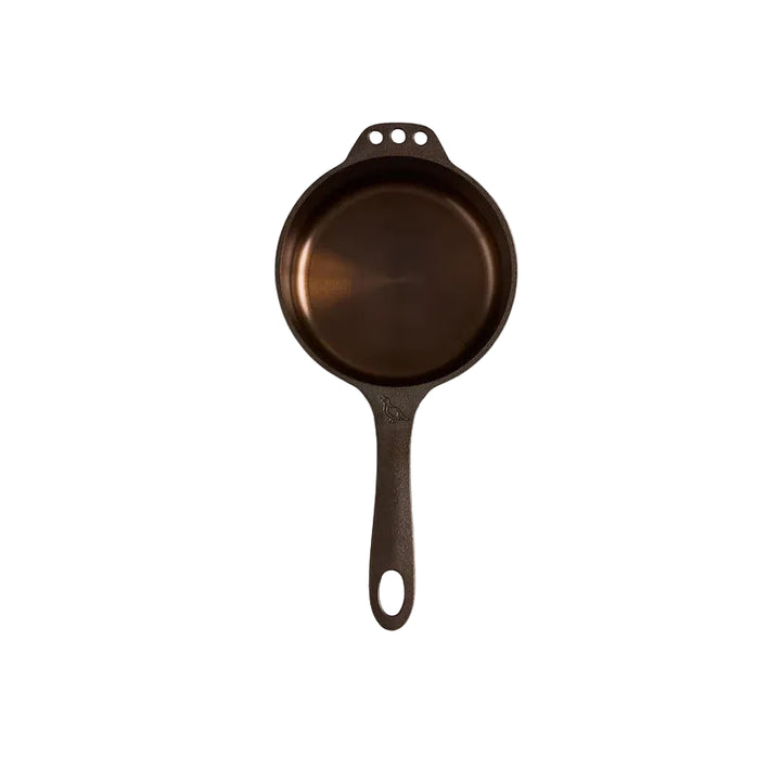 Cast iron skillet on a light gray background