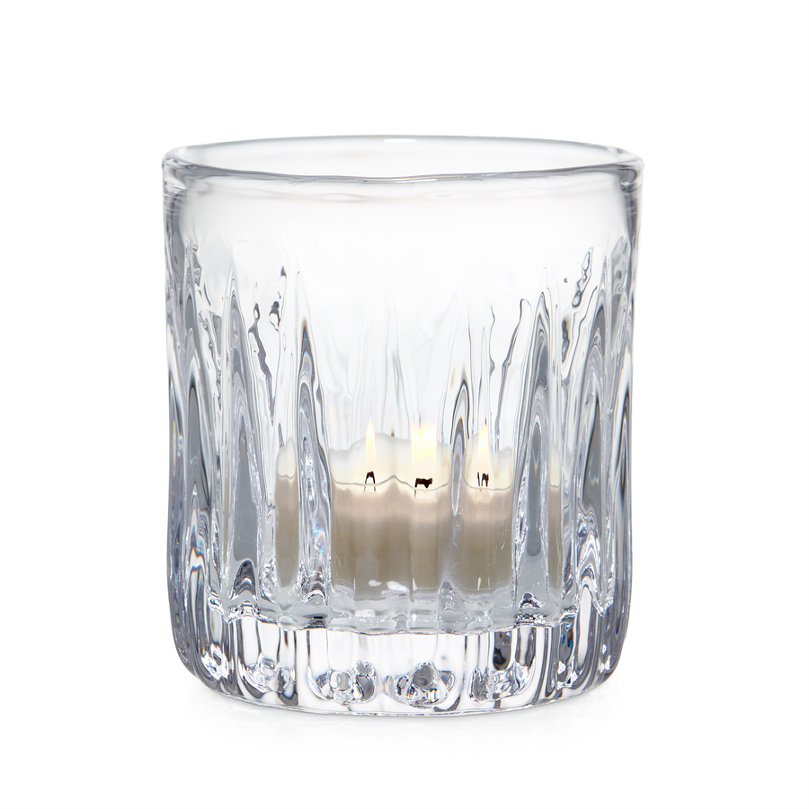 Clear glass candle holder with a candle inside 