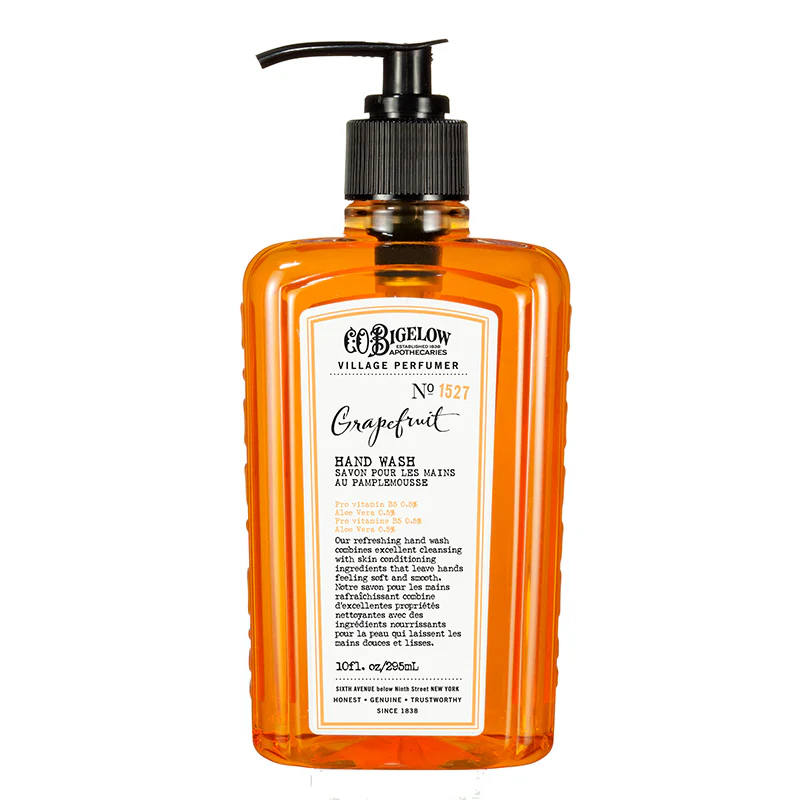 Orange bottle of Village Perfumer grapefruit hand wash with a pump 
