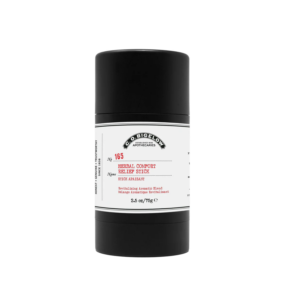 a black cylindrical container with a white label reading "CO Bigelow Apothecaries Herbal Comfort Relief Stick