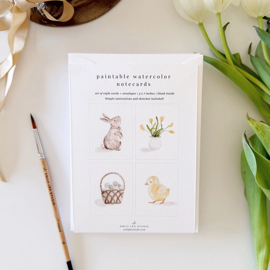 Set of paintable watercolor notecards with illustrations with flowers and a brush.
