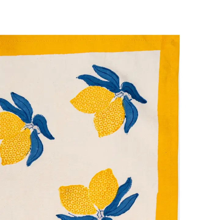 Tea towel with yellow and blue lemon design on a white background