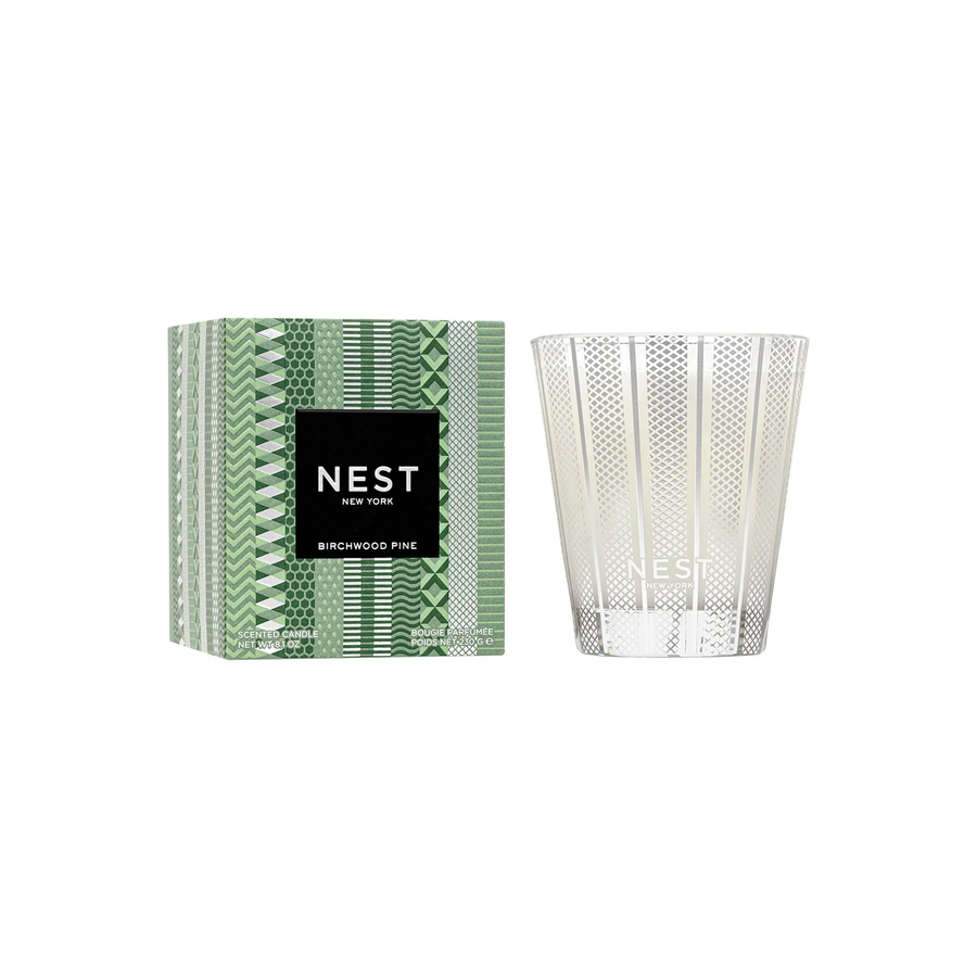 Nest birchwood pine candle in a clear holder with packaging on a white background