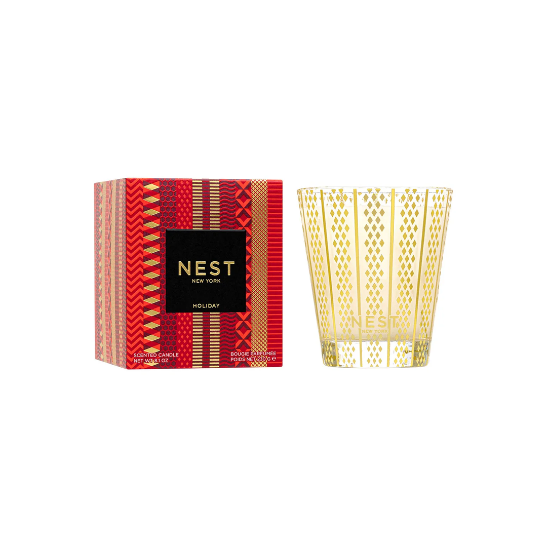  NEST New York holiday candle with gold and red packaging on a white background