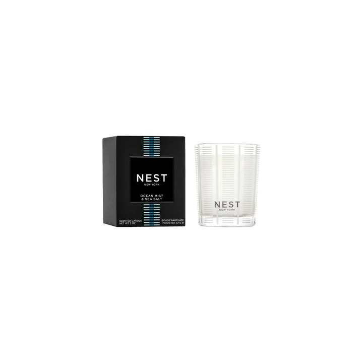 Nest Ocean Mist and Sea Salt votive candle next to its packaging