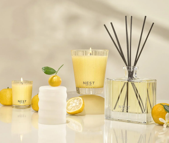 NEST sunlit Yuzu and Neroli votive and classic candles and a diffuser featuring decorative yuzu