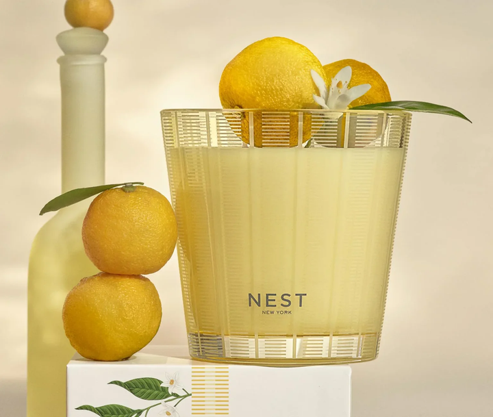 NEST New York sunlit yuzu and neroli candle with lemons and a white flower 