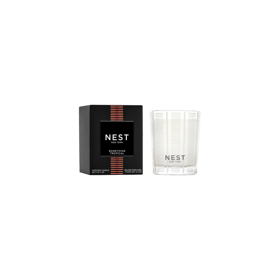 A Nest Something Tropical votive candle next to its packaging