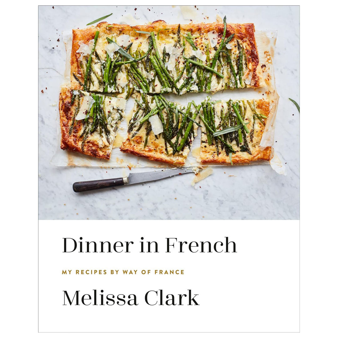Book cover of 'Dinner in French' by Melissa Clark with a pastry dish on marble.