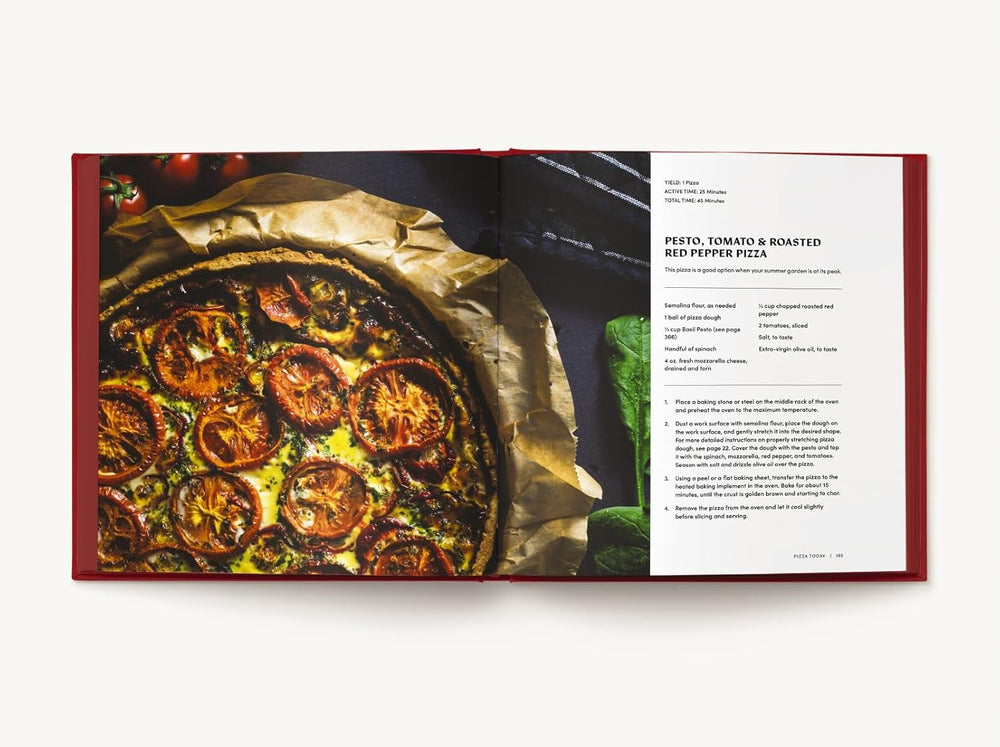 An open recipe book preview of a page with a recipe for pesto tomato and roasted red pepper pizza