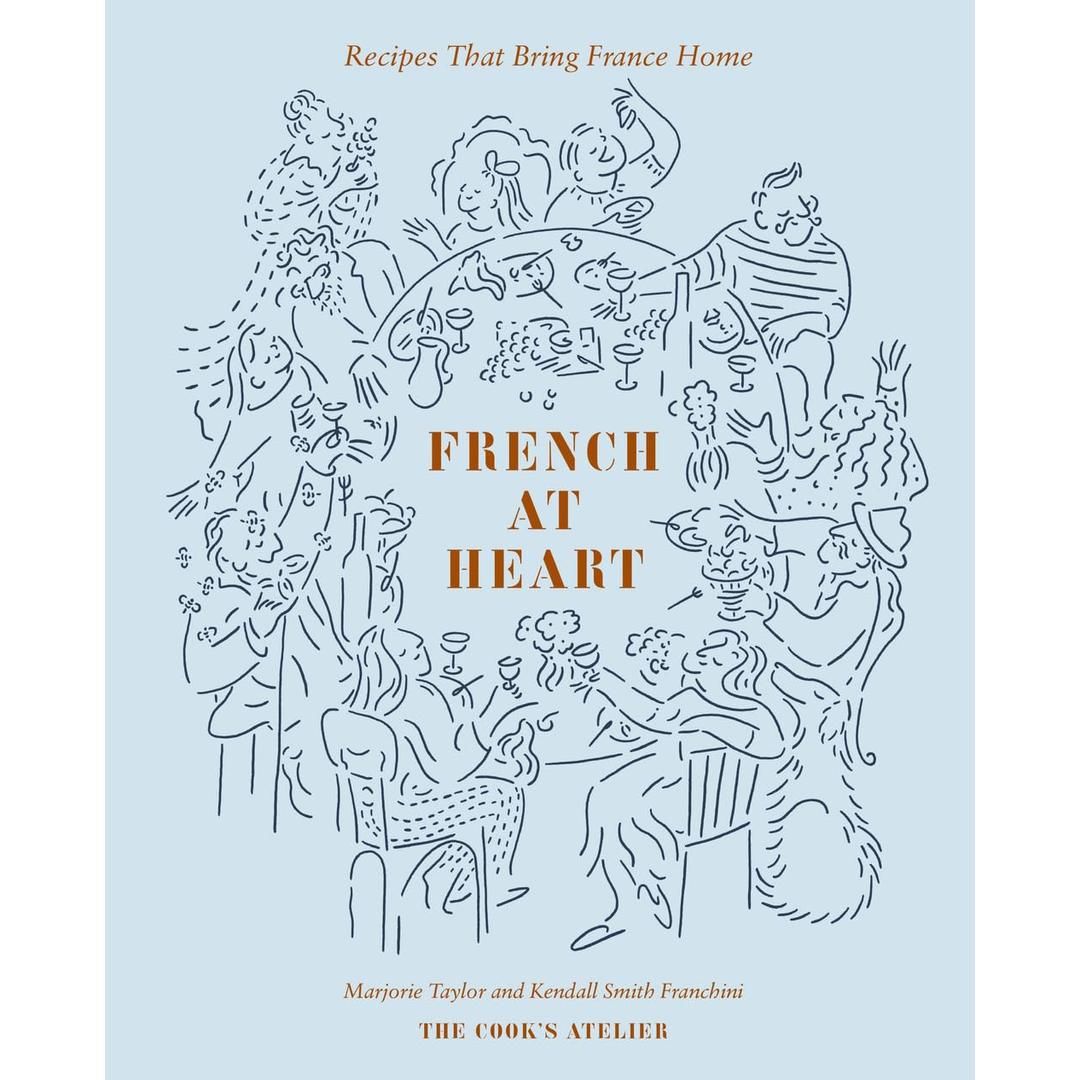 A light blue book cover titled "french at heart: recipes that bring france home" by marjorie tayler and kendall smith franchini