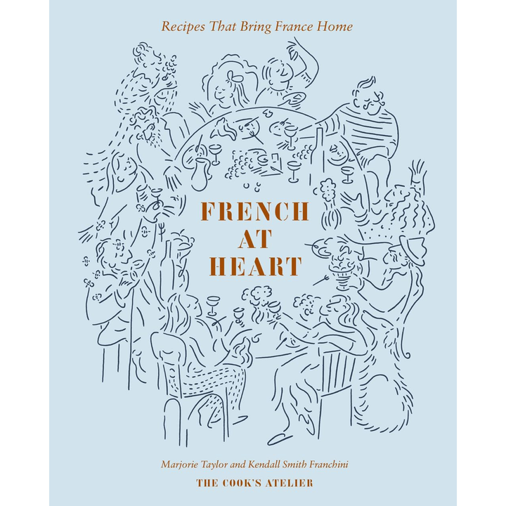 A light blue book cover titled "french at heart: recipes that bring france home" by marjorie tayler and kendall smith franchini