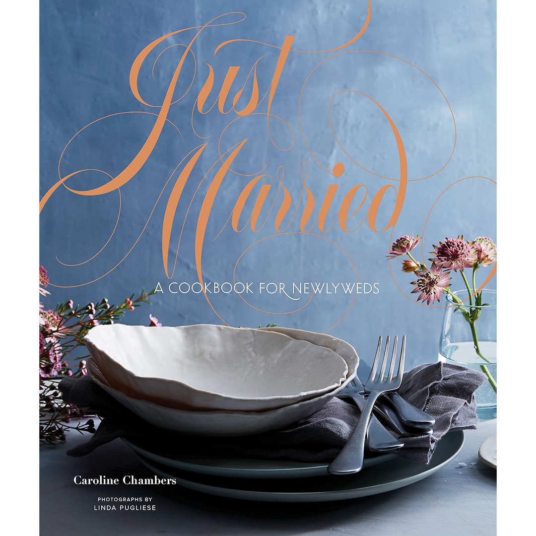 Cookbook cover titled 'Just Married' with a table setting and flowers on a blue background