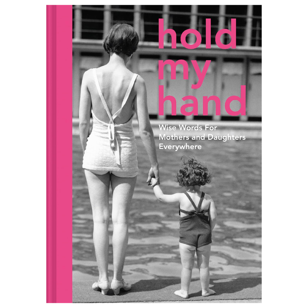 Book cover with a black and white photo of a woman and child holding hands, and pink text 'hold my hand'.