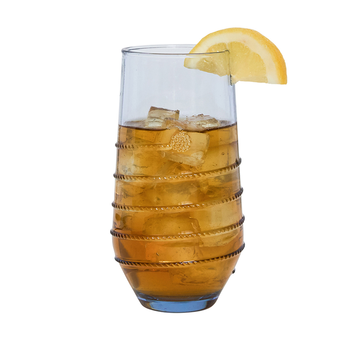 Glass of iced tea with lemon wedge on a white background