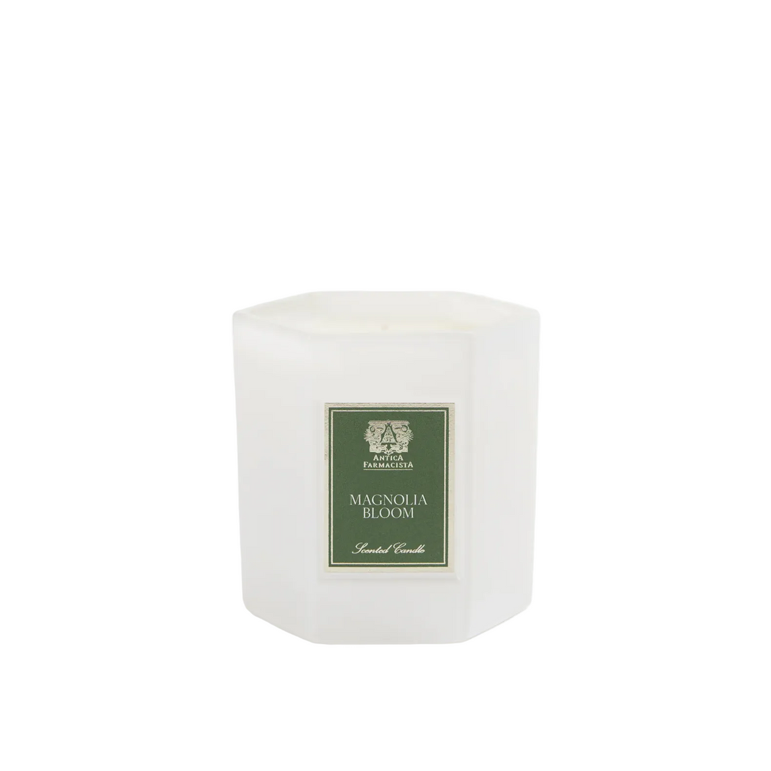White candle with a green label