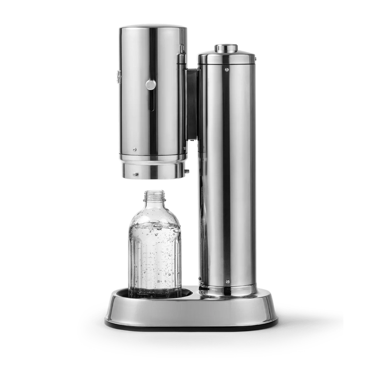 A stainless steel carbonation machine with a clear plastic bottle placed under the dispensing head, shown on a clean white background.