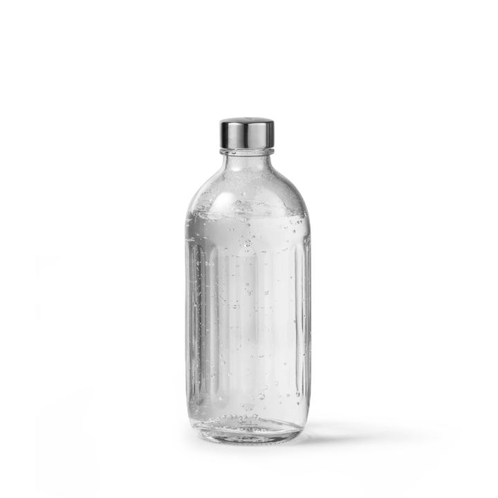 A clear glass bottle with a ribbed cylindrical body, a silver metal cap, and visible air bubbles inside, shown on a clean white background.