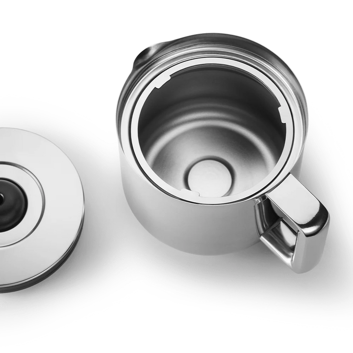 A stainless steel travel mug shown open with its lid placed beside it on a clean white background.