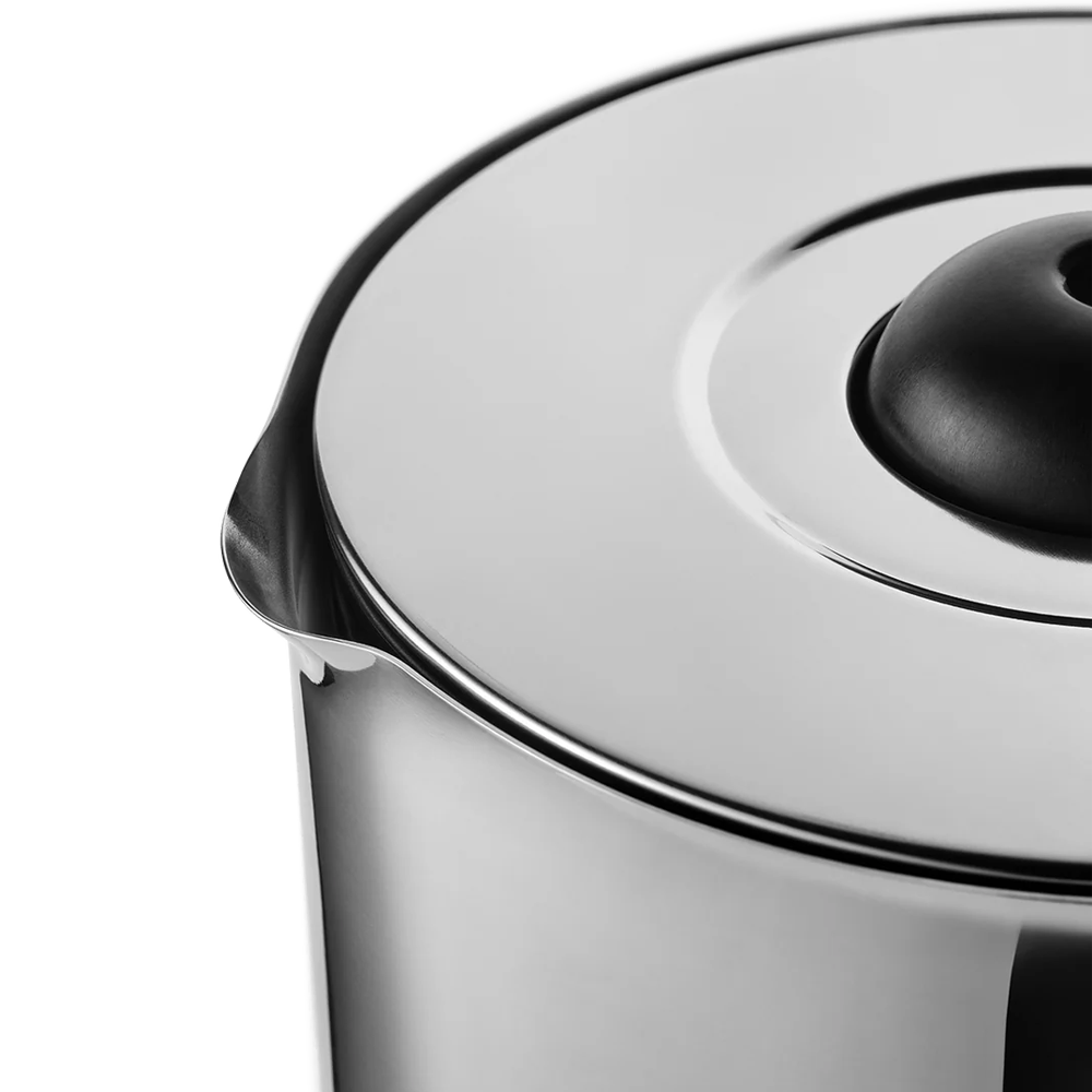 Close-up of a stainless steel electric kettle showing the polished metal body, rim, and lid with a black central knob against a white background.