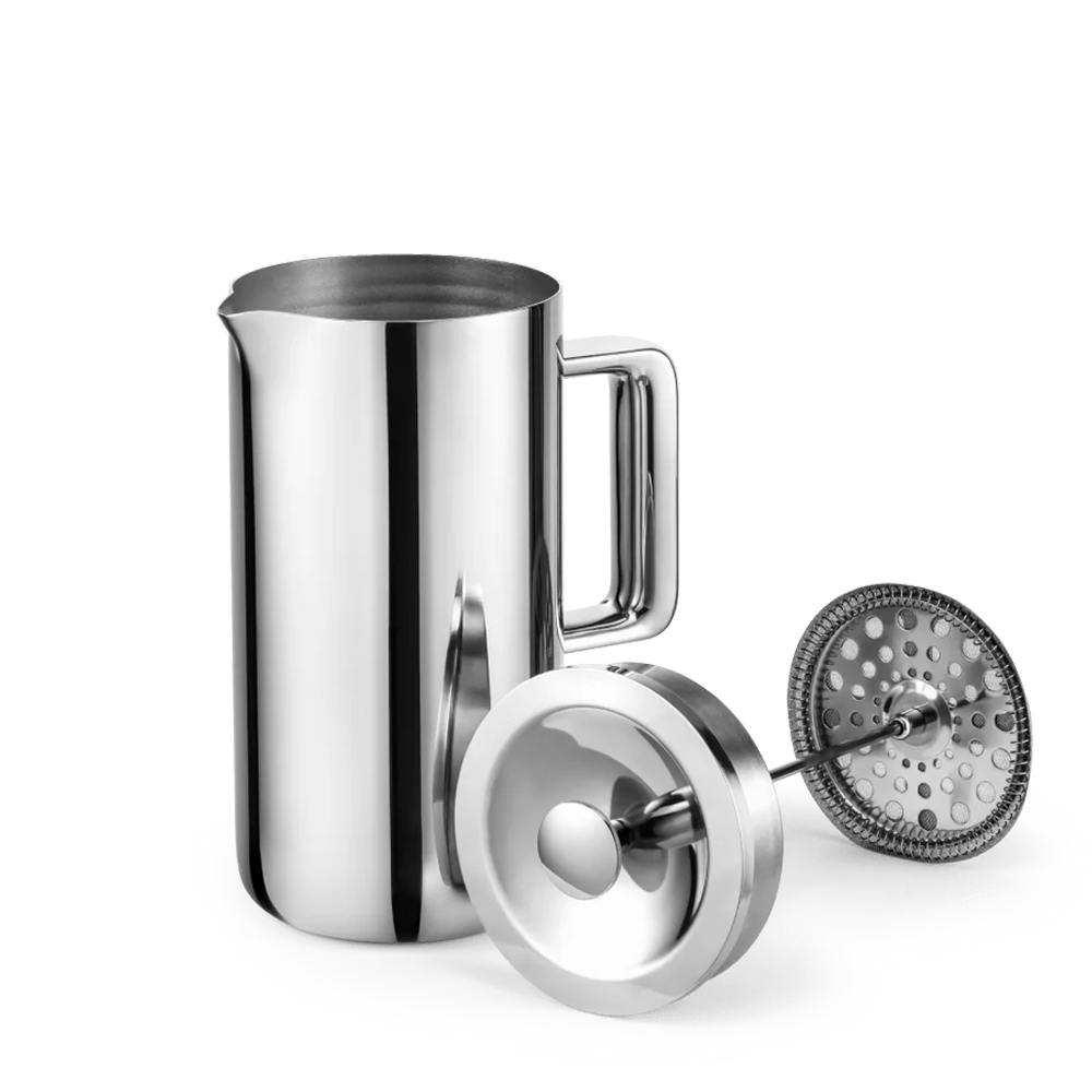 A stainless steel milk frother pitcher with a handle, shown with its lid and frothing insert on a clean white background.