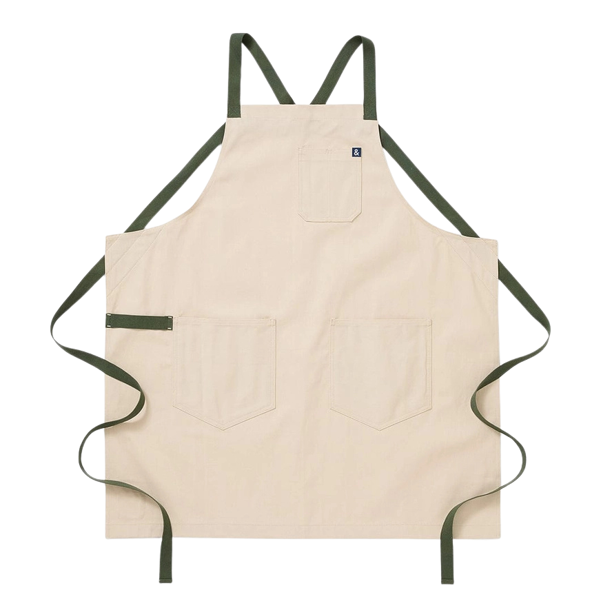 white apron with sage green straps on a white background