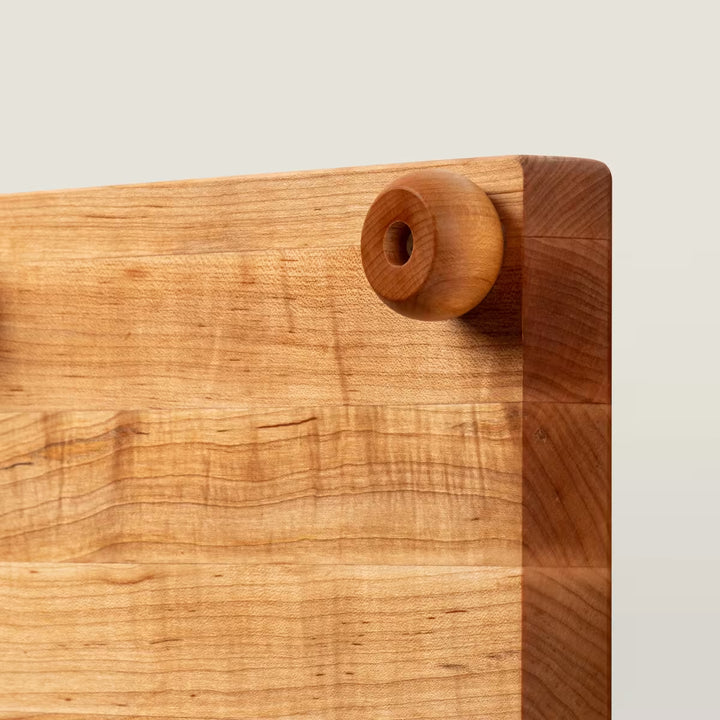 Wooden cutting board with a handle on a light background