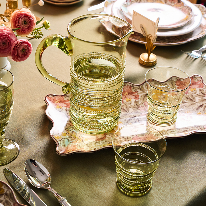 Decorative glassware on a table with floral arrangements and silverware.