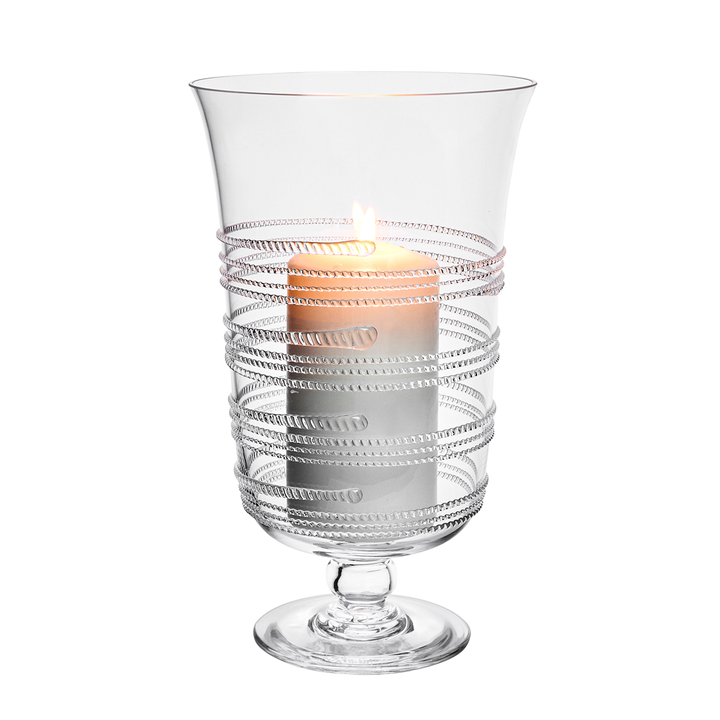 Clear glass candle holder with ribbed design on a white background