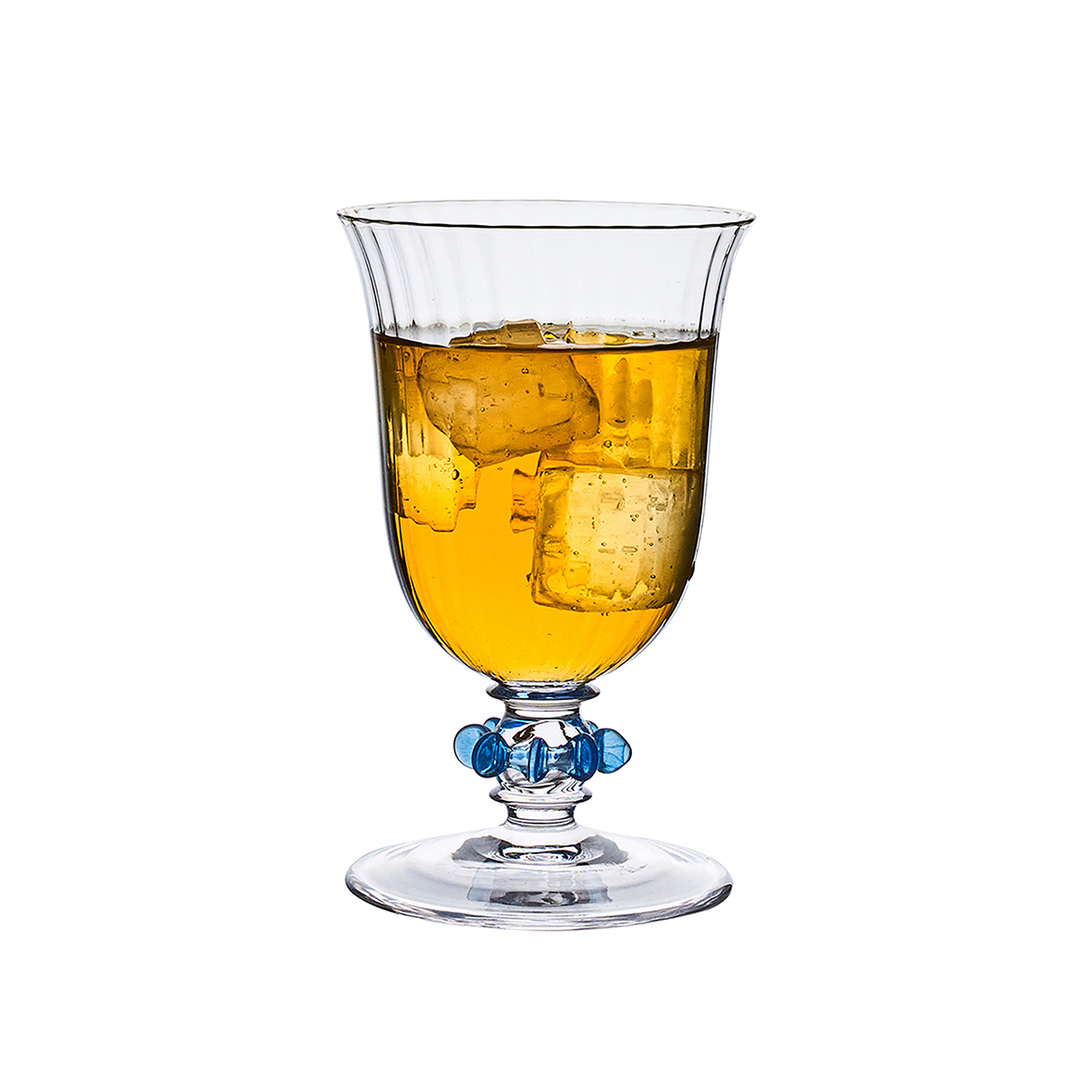Clear glass with amber liquid and ice cubes on a white background