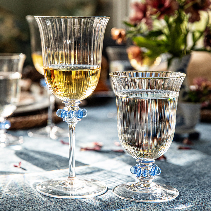 Two elegant glass goblets on a table with a blurred background