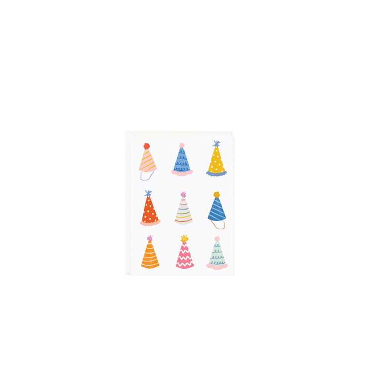 Colorful birthday hats on a white greeting card
