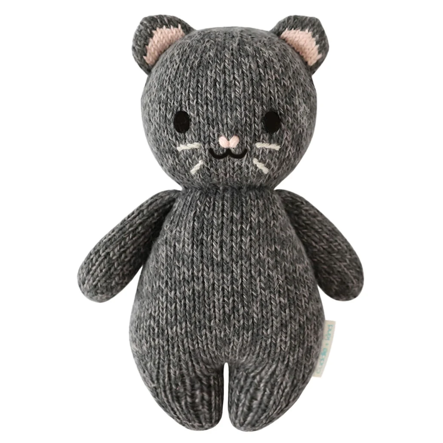 A small knitted cat-shaped plush toy in dark gray with pink inner ears, black embroidered eyes and nose, and white whiskers