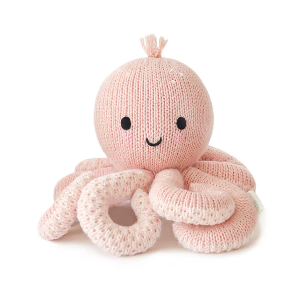 Knitted pink octopus toy with a smiling face