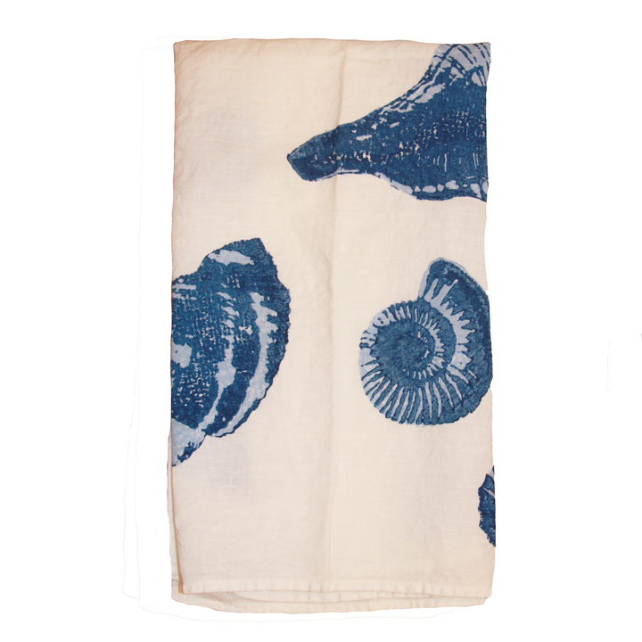 White folded linen kitchen towel with blue seashell print