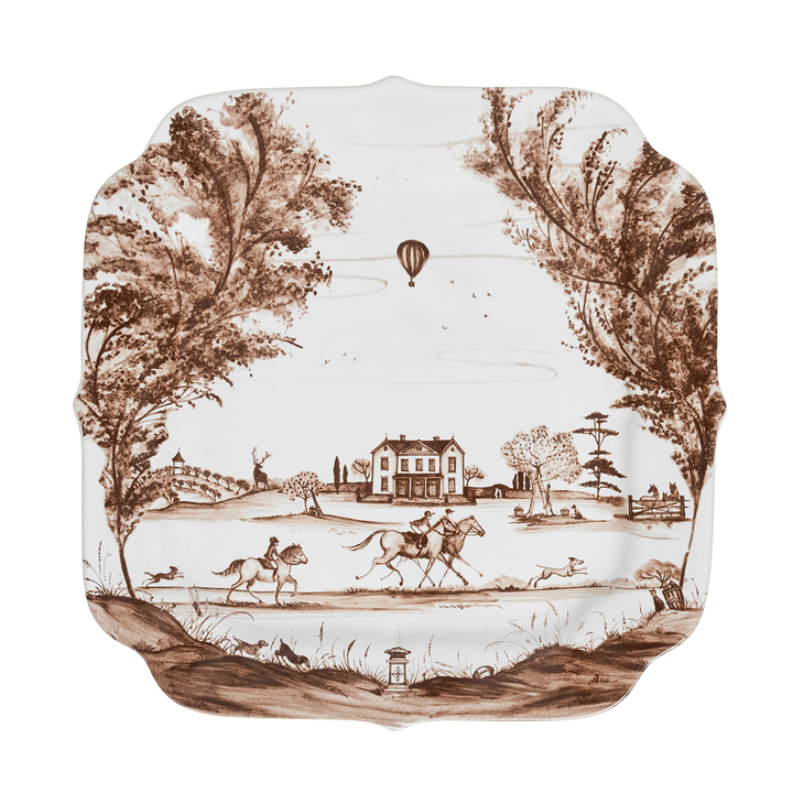 Decorative plate with brown landscape design featuring trees, a house, and animals on a white background