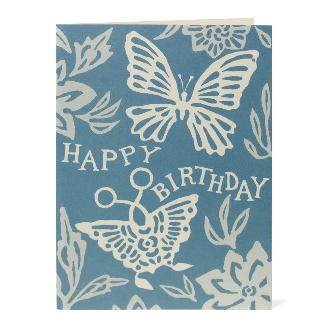 Blue birthday card with white butterfly designs and 'Happy Birthday' text