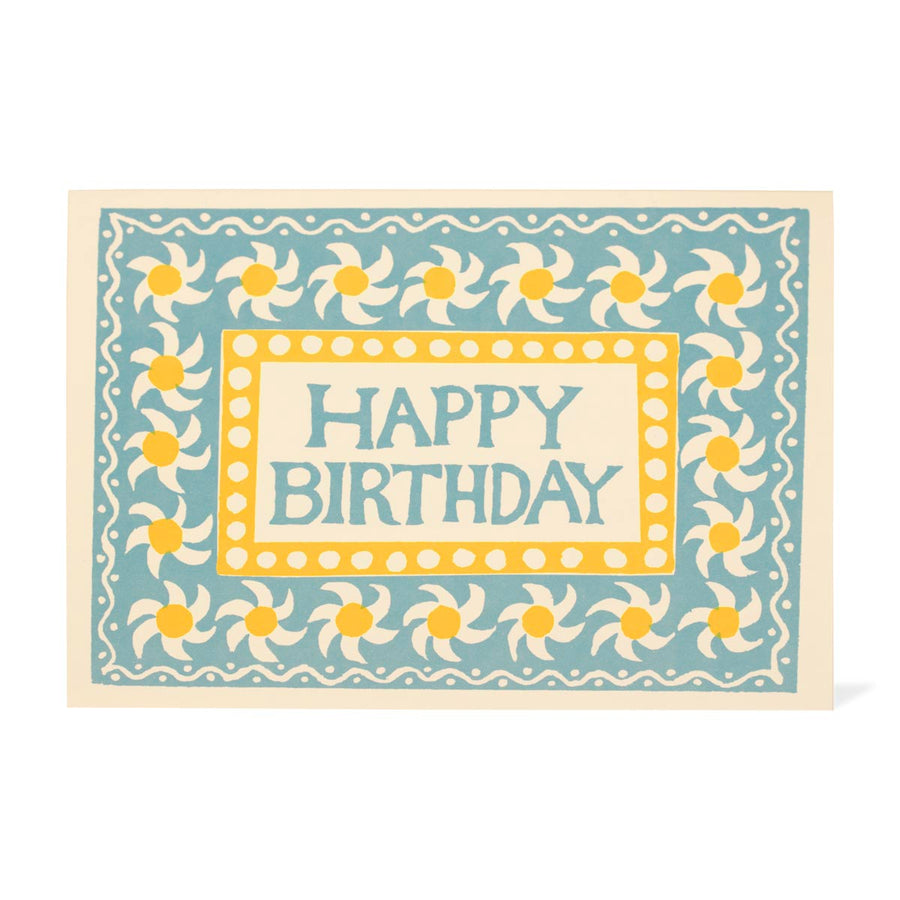 Birthday card with decorative daisy pattern and 'Happy Birthday' text on a light blue background.