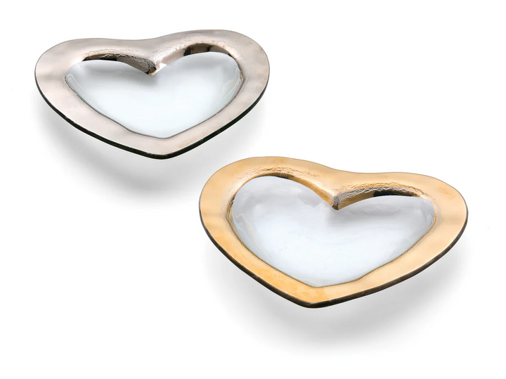 Two clear glass heart shaped bowls, one with a gold edge and the other silver