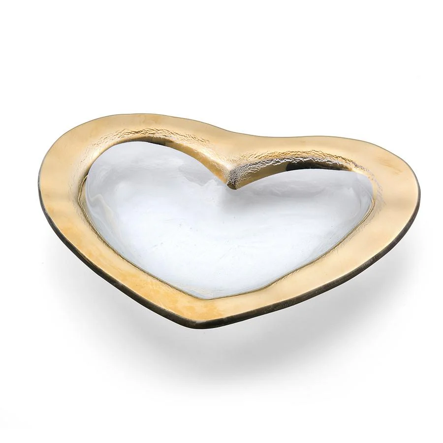 A clear glass heart shaped bowl with a gold edge 