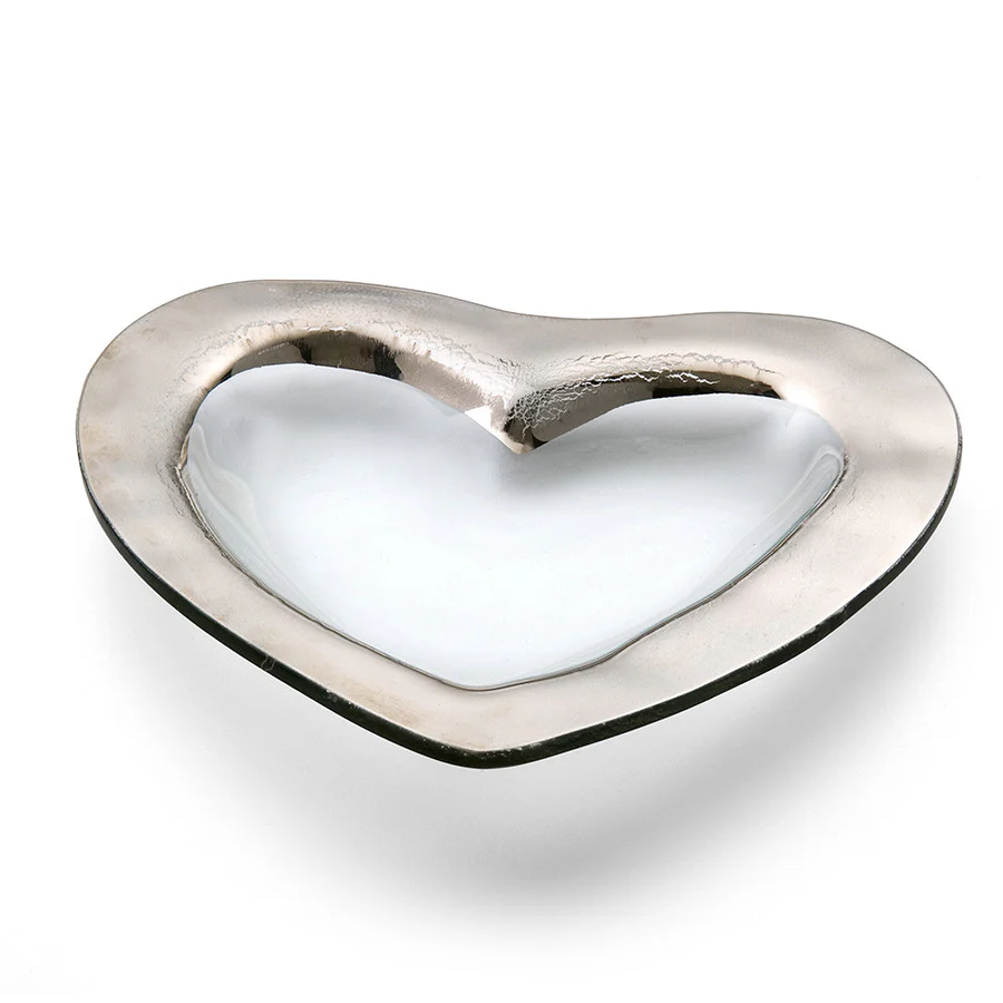 A clear glass heart shaped bowl with a silver edge