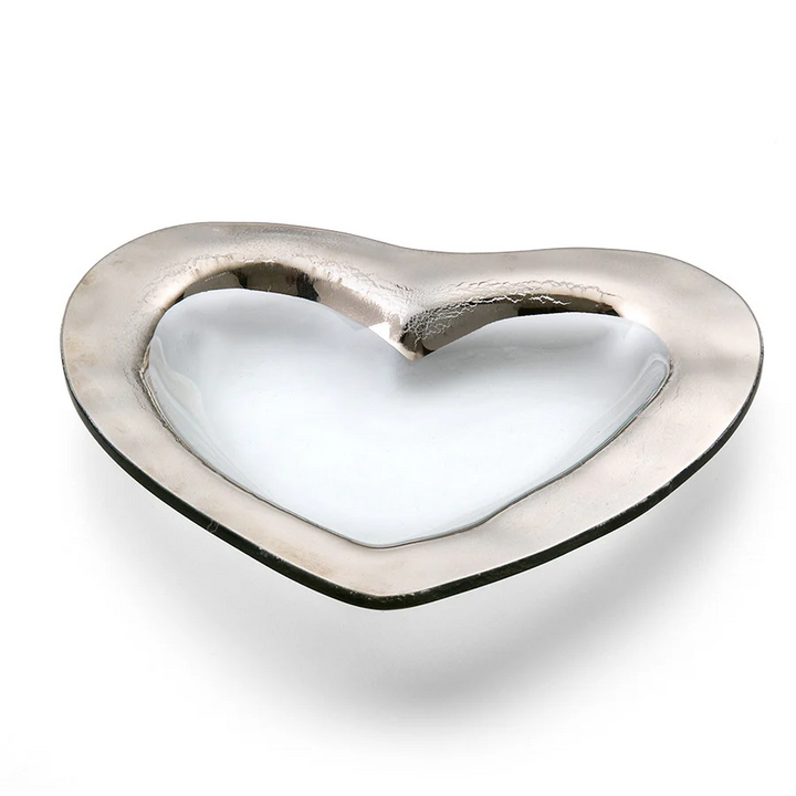 A clear glass heart shaped bowl with a silver edge