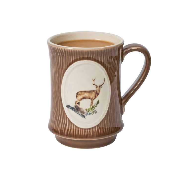 Brown mug with a deer design filled with coffee