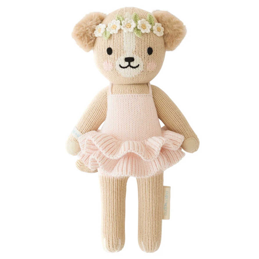 Knitted puppy in a tutu with a flower crown on