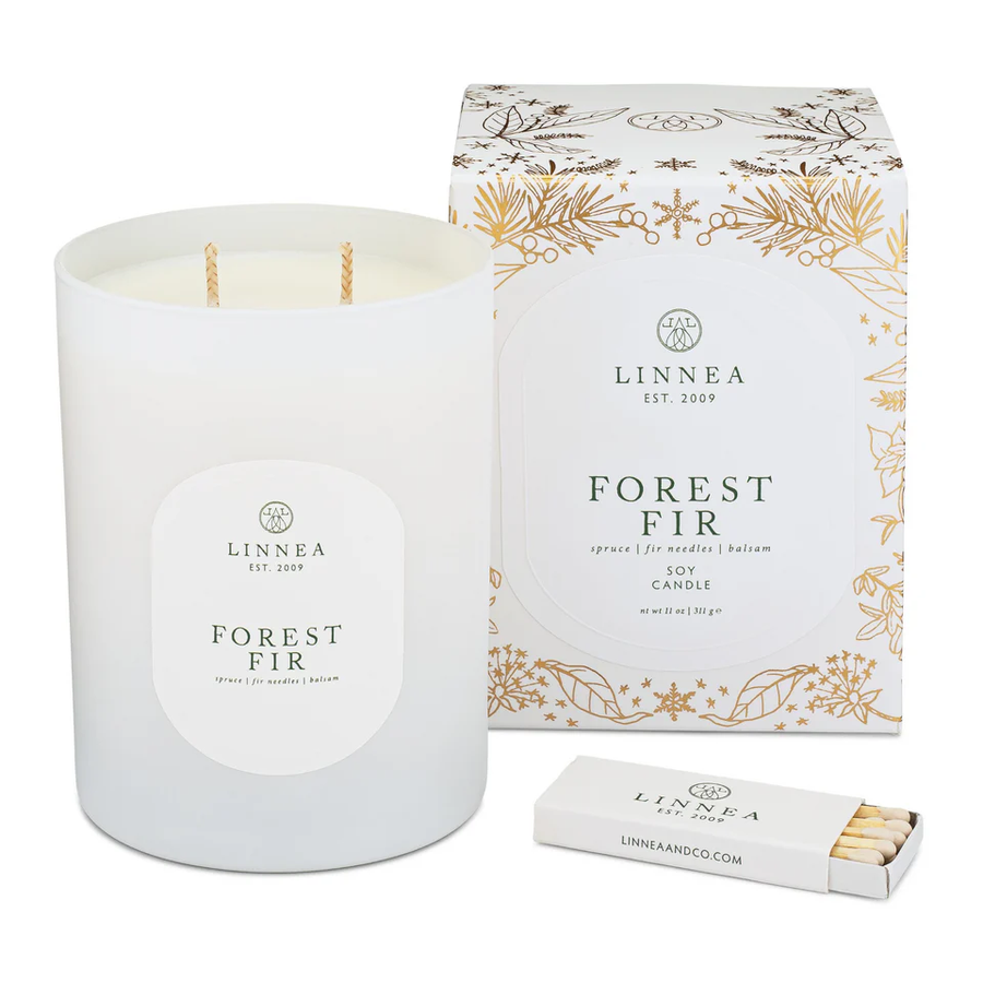 LINNEA Forest Fir candle with gilded packaging and matches on a white background