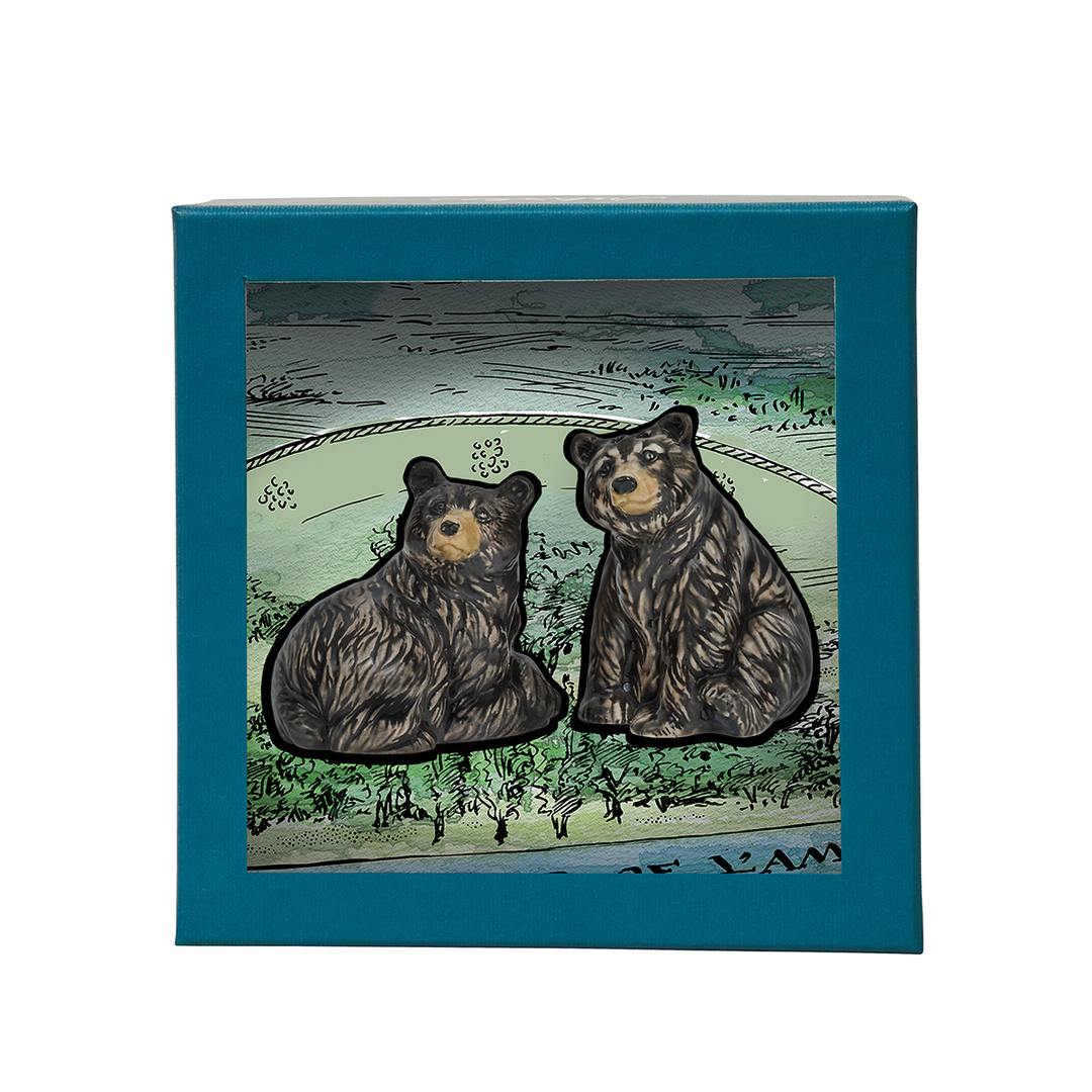 Two bear figurines on a card with a blue border