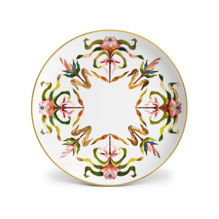 A white porcelain plate with floral patterns and a gold rim