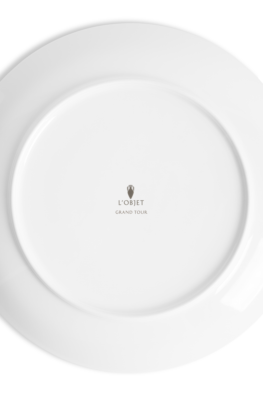 The underside of a white plate with the L'Objet logo
