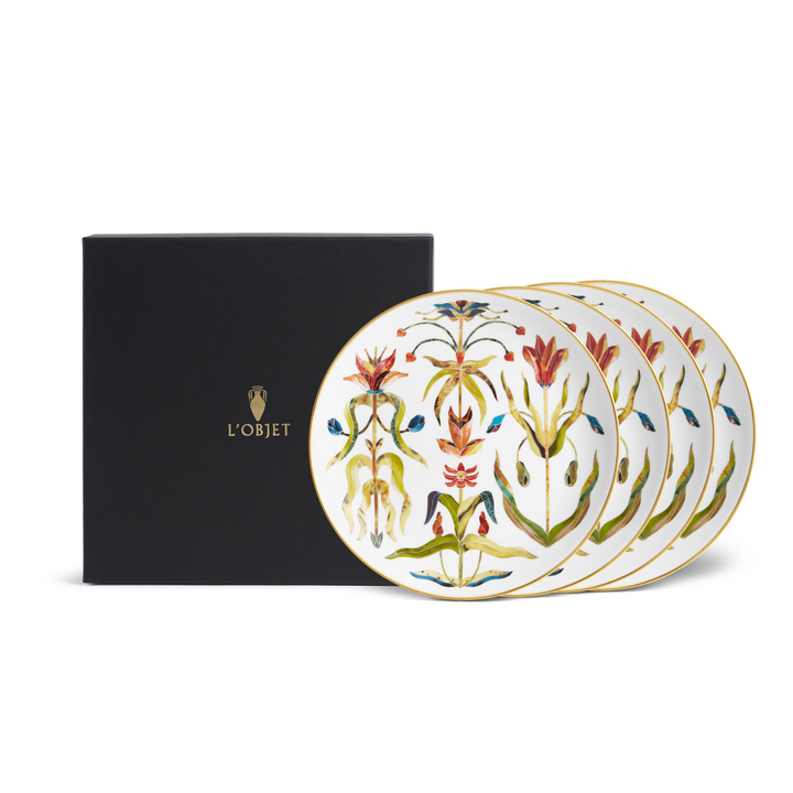 A set of four white porcelain plates with a l'objet box
