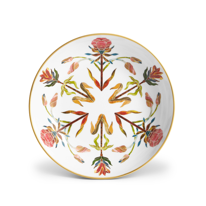 A white porcelain bowl with painted floral patterns and a gold rim